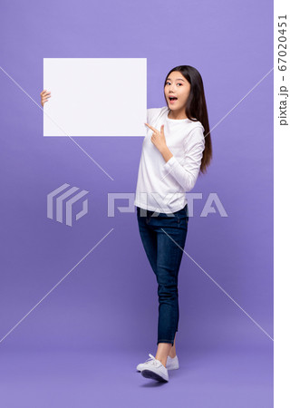 Smiling cheerful Asian woman pointing hand to blank paper board 67020451