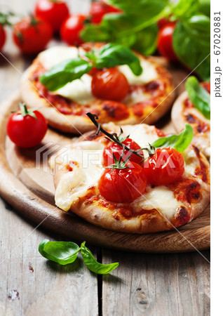 Mini pizza with mozzarella and tomato Mini pizza with mozzarella and tomato 67020881