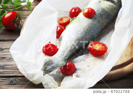 Cooked seabass with tomato and parsley Cooked seabass with tomato and parsley 67022788