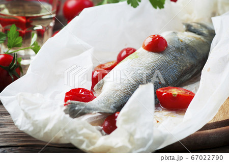 Cooked seabass with tomato and parsley 67022790