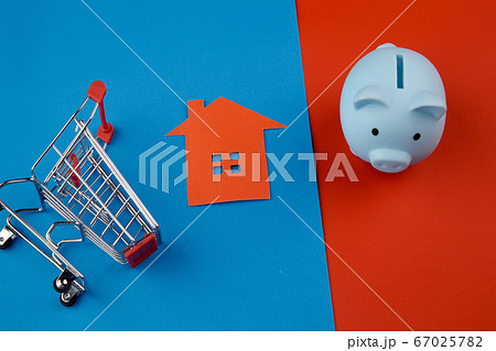 Mortgage concept. Piggy bank and mini house on colorful background Mortgage concept. Piggy bank and mini house on colorful background 67025782
