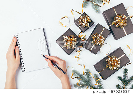 Top view female hands writing Christmas list 67028657