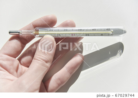 thermometer in the female hand 67029744