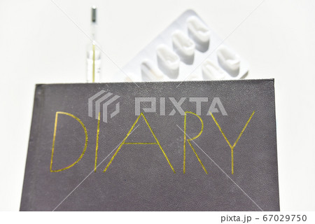 selective focus of the diary with thermometer and selective focus of the diary with thermometer and 67029750