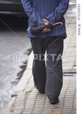 Back view of man walking on the street with 67030093