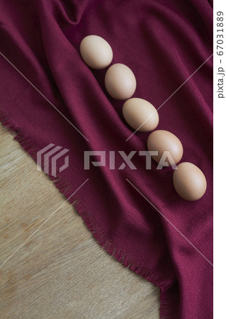 Natural eggs on wooden table, several brown 67031889