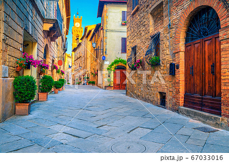 Rustic brick and stone houses decorated with colorful flowers, Italy Rustic brick and stone houses decorated with colorful flowers, Italy 67033016