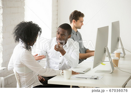 Serious african american colleagues talking discussing project t 67036076