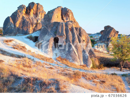 Cave Dwellings in an Arid Landscape in Cappadocia Cave Dwellings in an Arid Landscape in Cappadocia 67036626