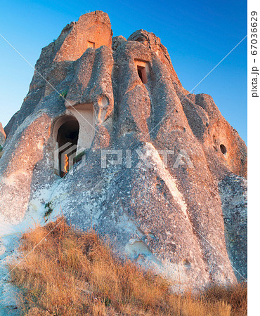 Cave Dwellings in an Arid Landscape in Cappadocia Cave Dwellings in an Arid Landscape in Cappadocia 67036629