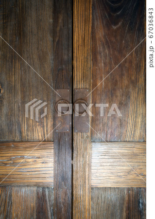 Beautiful brown wooden oak doors of a cabinet with rusty metal modern handles modern background texture 67036843