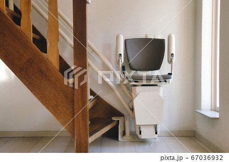 Automatic stairlift on staircase for elderly or disability in a house, 67036932