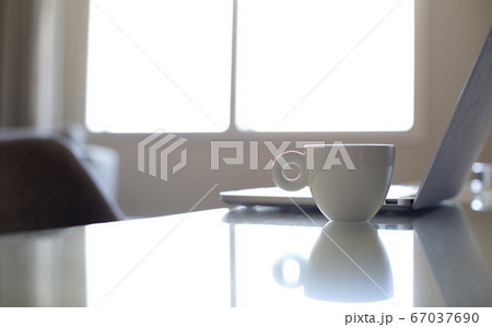 White coffee mug beside laptop computer White coffee mug beside laptop computer 67037690