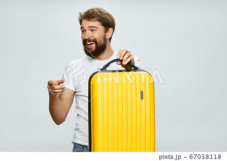 Man travel yellow suitcase emotions gesticulate hands 67038118
