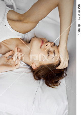 woman lies on bed sleeping woman lies on bed sleeping 67038396