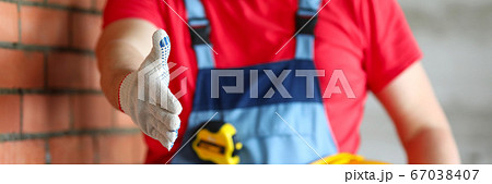 Builder at object holds out his hand for greeting Builder at object holds out his hand for greeting 67038407