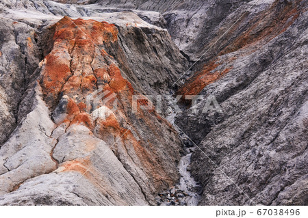 gully in a clay slope devoid of soil 67038496
