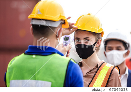 Officer checking fever team engineer and technician foreman with digital thermometer. 67046038