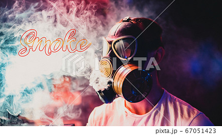 male smoker in a gas mask smokes hookah smoke 67051423