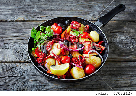 Baby octopus with young potatoes on a frying pan Baby octopus with young potatoes on a frying pan 67052127