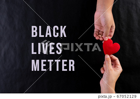 Woman hand giving red heart to child. Black lives matter concept. 67052129