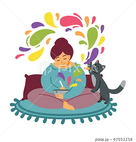 Girl draws on a tablet. The cat plays on the carpet. Woman cozily spends time at favourite job. 67052256