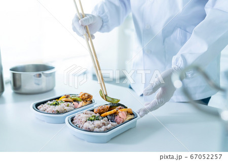 弁当を盛り付ける男性調理師　宅食　デリバリー　テイクアウト 67052257