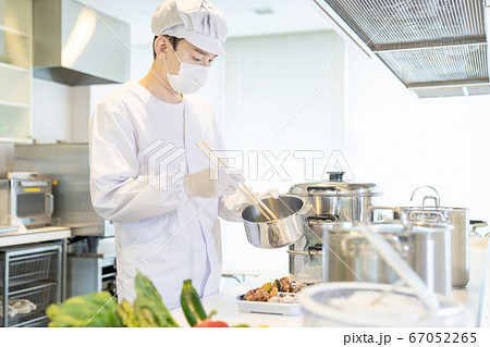 弁当を盛り付ける男性調理師　宅食　デリバリー　テイクアウト 67052265