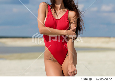 Beautiful woman in swimsuit on beach 67052872