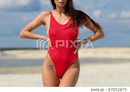 Beautiful woman in swimsuit on beach Beautiful woman in swimsuit on beach 67052873