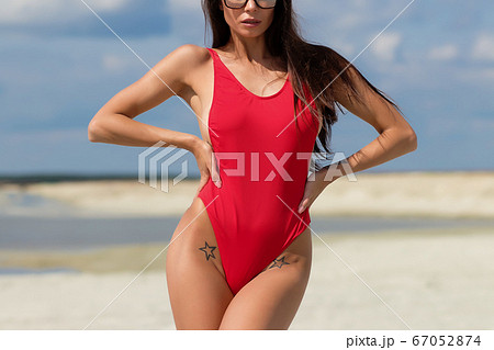 Beautiful woman in swimsuit on beach Beautiful woman in swimsuit on beach 67052874