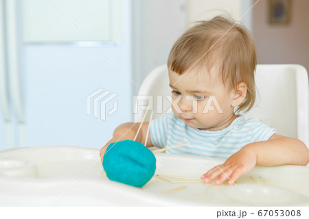 girl sculpts from plasticine. a child makes a hedgehog craft. development of fine motor skills with toothpicks girl sculpts from plasticine. a child makes a hedgehog craft. development of fine motor skills with toothpicks 67053008