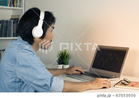 Asian Forex Trader or Investor Wear Headphone Looking Forex or Stock Chart in Vintage Tone Asian Forex Trader or Investor Wear Headphone Looking Forex or Stock Chart in Vintage Tone 67053050