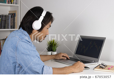 Young Asian Forex Trader or Investor Wear Headphone Trading Forex or Stock 67053057