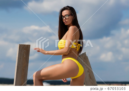 Beautiful woman in swimsuit on beach Beautiful woman in swimsuit on beach 67053103