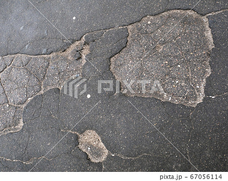 Cracked asphalt surface texture. 67056114