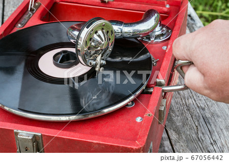 old retro gramophone with a vinyl record old retro gramophone with a vinyl record 67056442