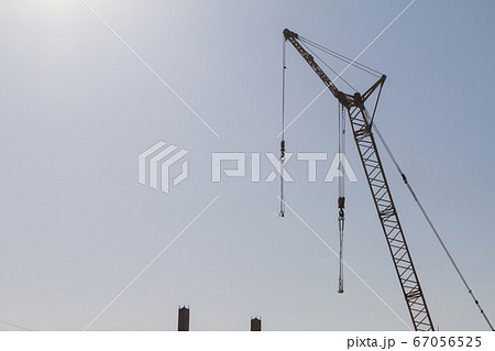 Construction crane on the background of the blue sky Construction crane on the background of the blue sky 67056525