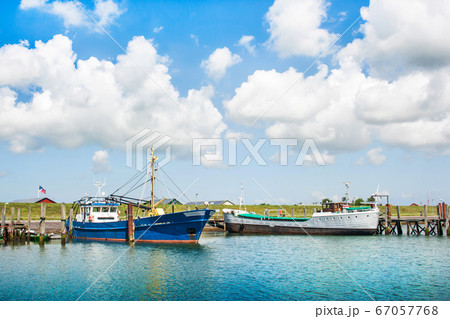 Traditional fishing boats lying in harbor at North Sea 67057768