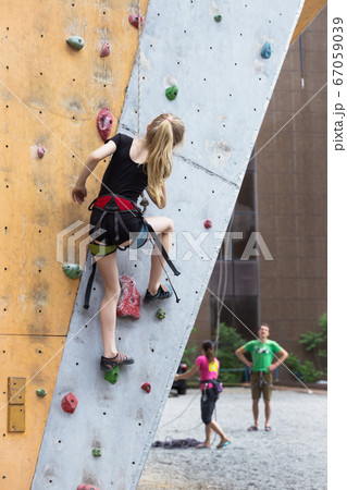 little girl climbing up the wall 67059039