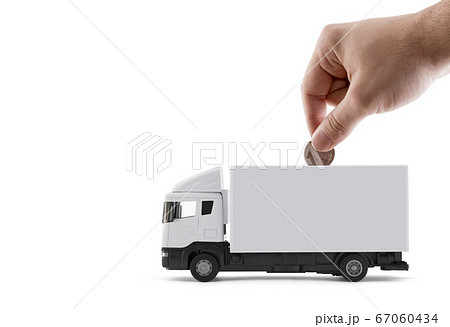 Putting coin into the white cargo delivery truck on white background 67060434
