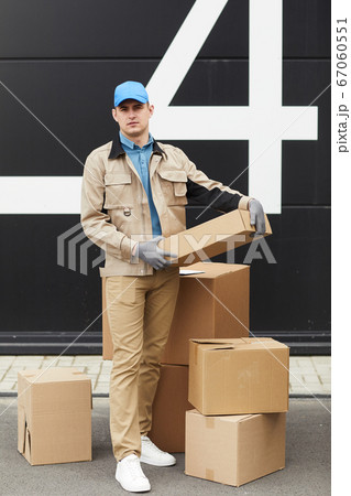 Courier working with parcels in warehouse Courier working with parcels in warehouse 67060551