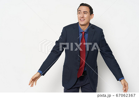 A businessman looks with interest to the side, gesturing A businessman looks with interest to the side, gesturing 67062367