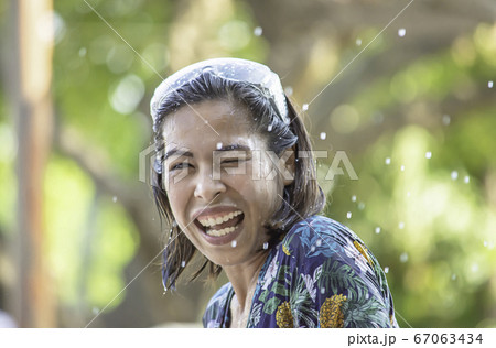 Asian woman play water in Songkran festival or Thai new year in Thailand. 67063434