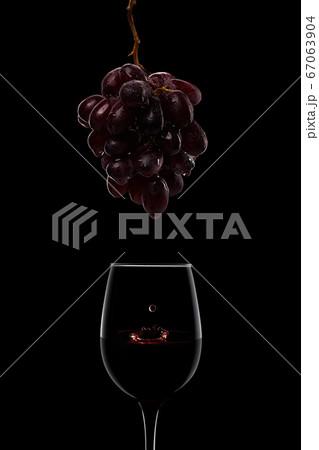 dark wet ripe grape bunch and wine glasses isolated on black 67063904