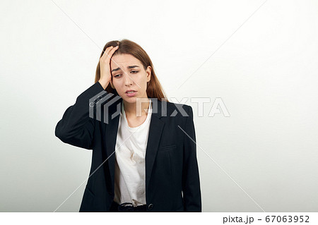 Forgetful holding hand to hair, touches head forgot something important regrets 67063952