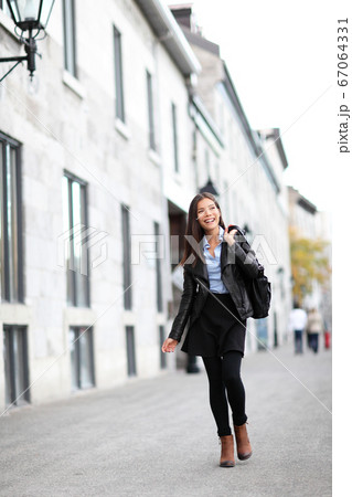 Urban modern woman walking in city street 67064331