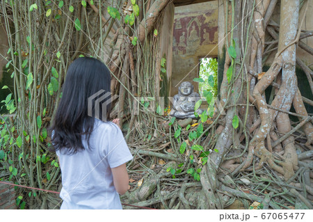 Asian woman, a tourist, praying hands or make a 67065477