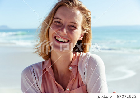 Portrait of woman smiling on the beach 67071925