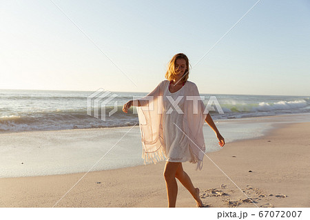Beautiful woman walking on the beach 67072007